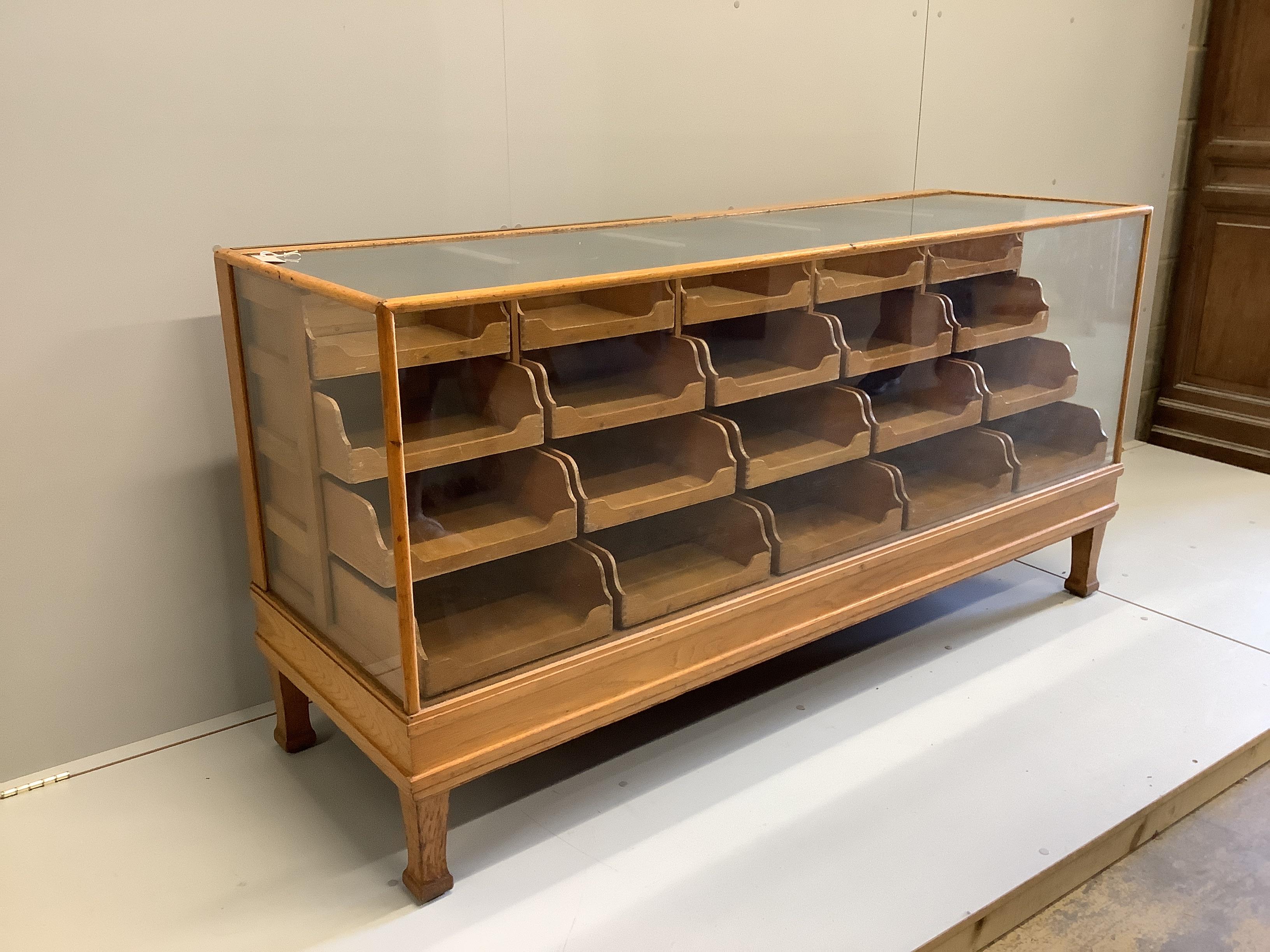 An early 20th century oak haberdashery cabinet, width 180cm, depth 58cm, height 91cm